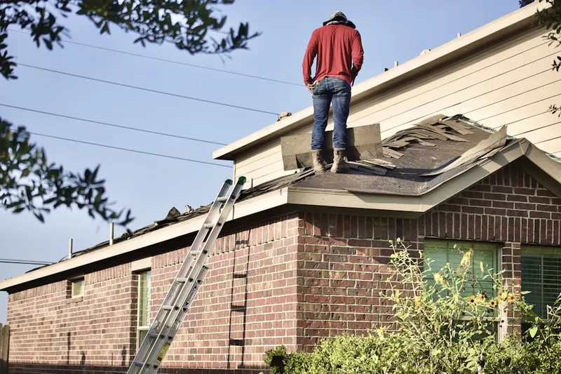Professional roofer working on a residential roof in North Edison
